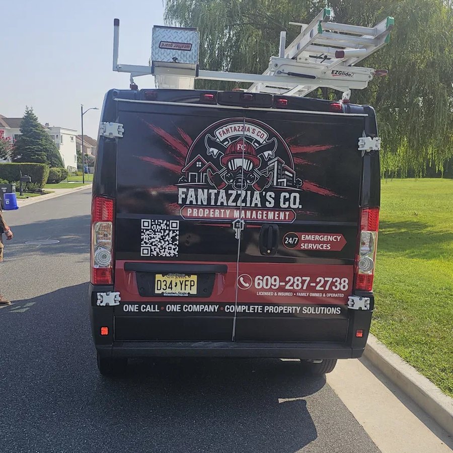 Rear of the wrapped Fantazzia Co van with the crest and phone number